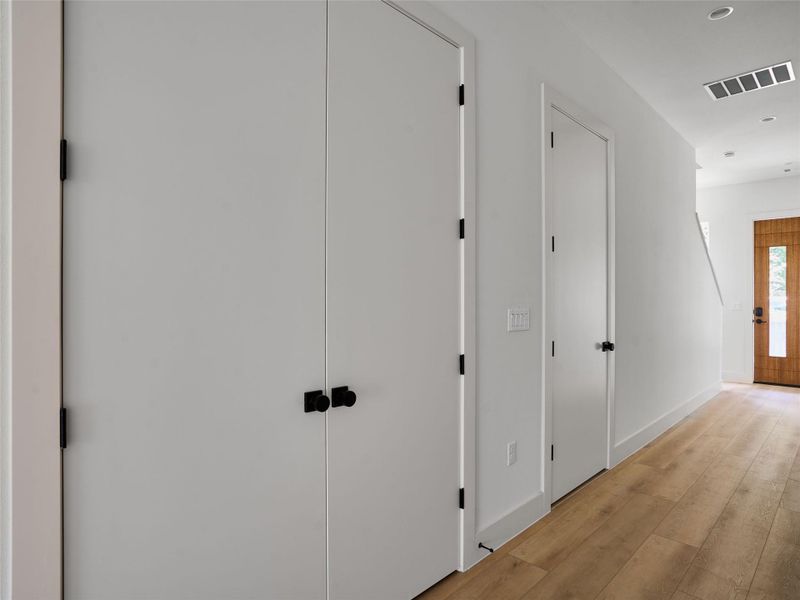 Hall with hardwood / wood-style floors and recessed lighting Hall with hardwood / wood-style floors and recessed lighting