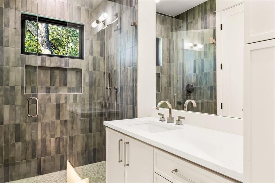 Bathroom with vanity and a shower stall Bathroom with vanity and a shower stall