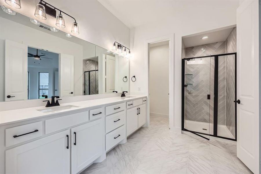 Bathroom with vanity, ceiling fan, and a shower with shower door