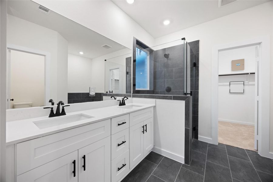 Custom tile flows from the floor up the shower walls Custom tile flows from the floor up the shower walls