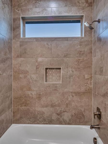 Bathroom featuring tiled shower / bath