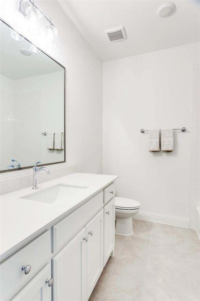 Bathroom featuring vanity and light tile patterned floors Bathroom featuring vanity and light tile patterned floors