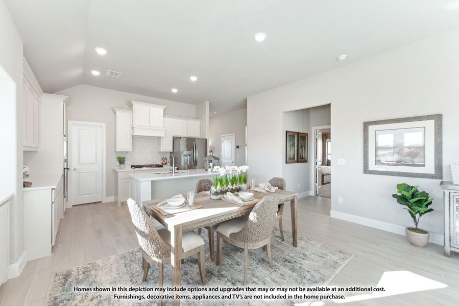 Open-concept dining area and kitchen with white cabinets, center island, and light wood-style floors Open-concept dining area and kitchen with white cabinets, center island, and light wood-style floors