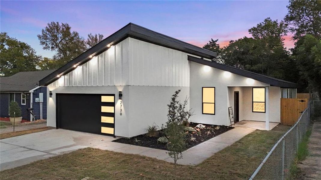 View of front facade featuring a garage