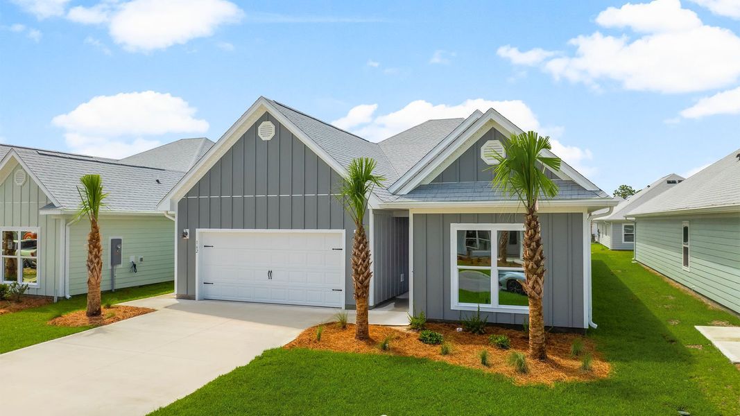 Front exterior of a new home in WindMark Beach, Port Saint Joe, FL, highlighting curb appeal (Image 21). Front exterior of a new home in WindMark Beach, Port Saint Joe, FL, highlighting curb appeal (Image 21).