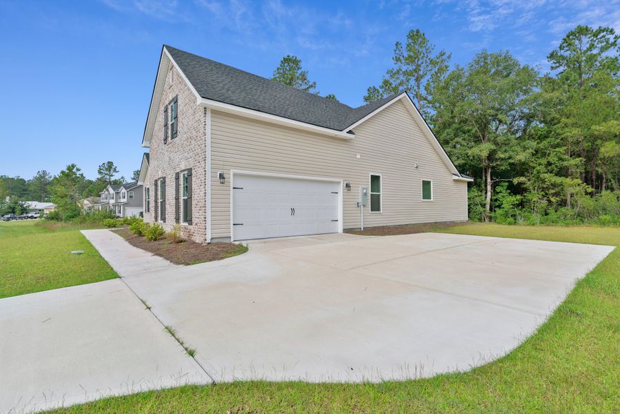 Front exterior of a new home in NorthShore on the St. Marys River, Kingsland, GA, highlighting curb appeal (Image 2). Front exterior of a new home in NorthShore on the St. Marys River, Kingsland, GA, highlighting curb appeal (Image 2).