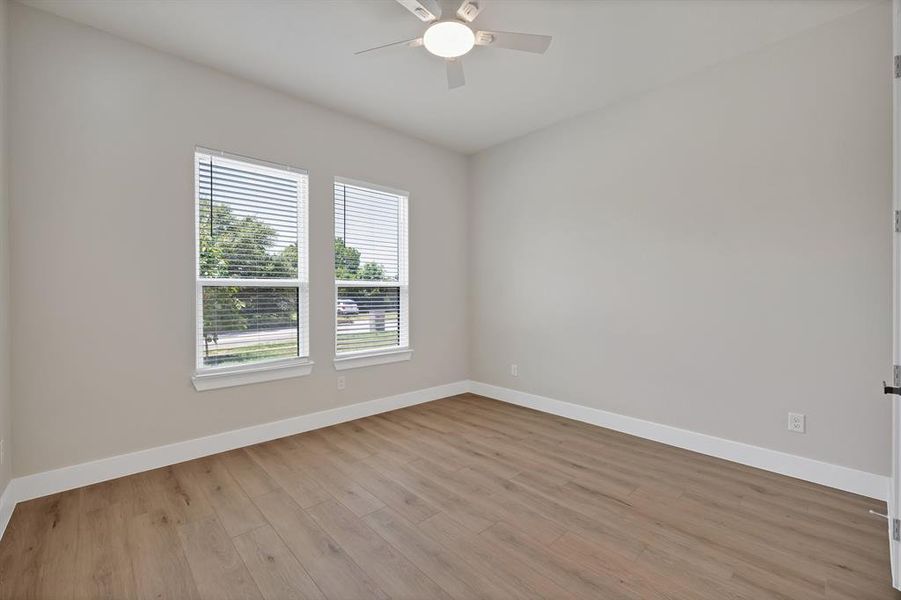 Spare room featuring baseboards, light wood-style flooring, and ceiling fan Spare room featuring baseboards, light wood-style flooring, and ceiling fan