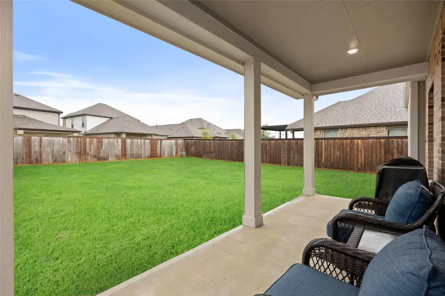 Step outside to a beautifully maintained backyard with lush green grass. Step outside to a beautifully maintained backyard with lush green grass.