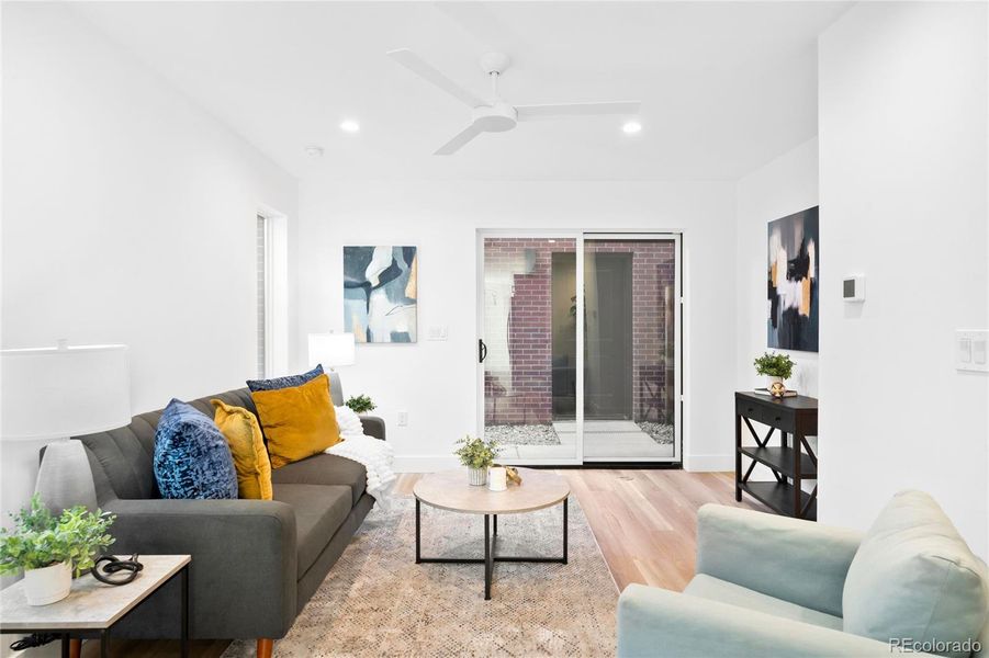 A bright living area opens to a private patio leading to the detached garage.