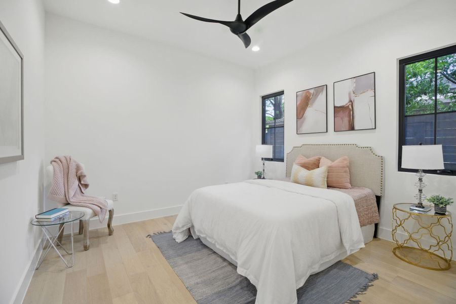 Bedroom featuring recessed lighting, multiple windows, wood finished floors, and baseboards