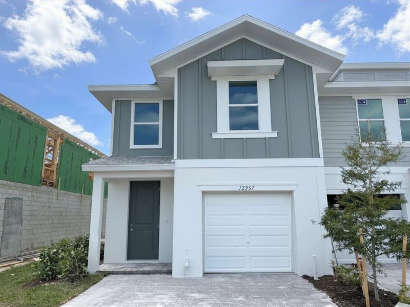 Front exterior of a new home in Meritage Homes at Central Park, Port St. Lucie, FL, highlighting curb appeal (Image 1). Front exterior of a new home in Meritage Homes at Central Park, Port St. Lucie, FL, highlighting curb appeal (Image 1).