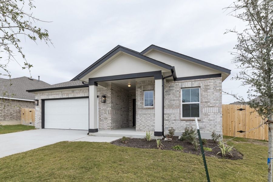 Front exterior of a new home in Village at Three Oaks, Seguin, TX, highlighting curb appeal (Image 25).