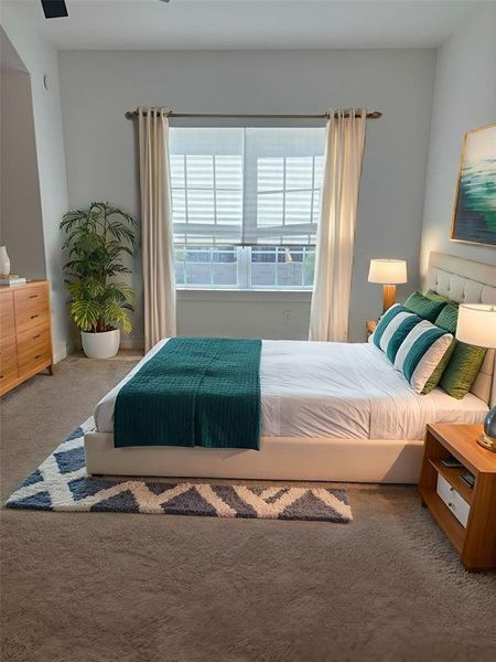 Carpeted bedroom with ceiling fan