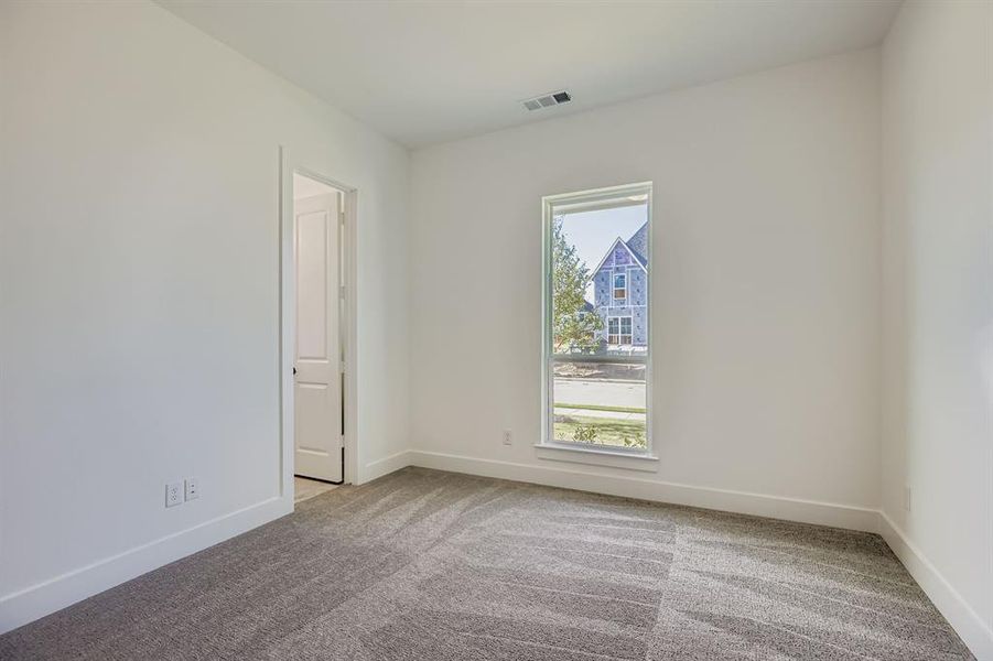 Carpeted empty room with baseboards