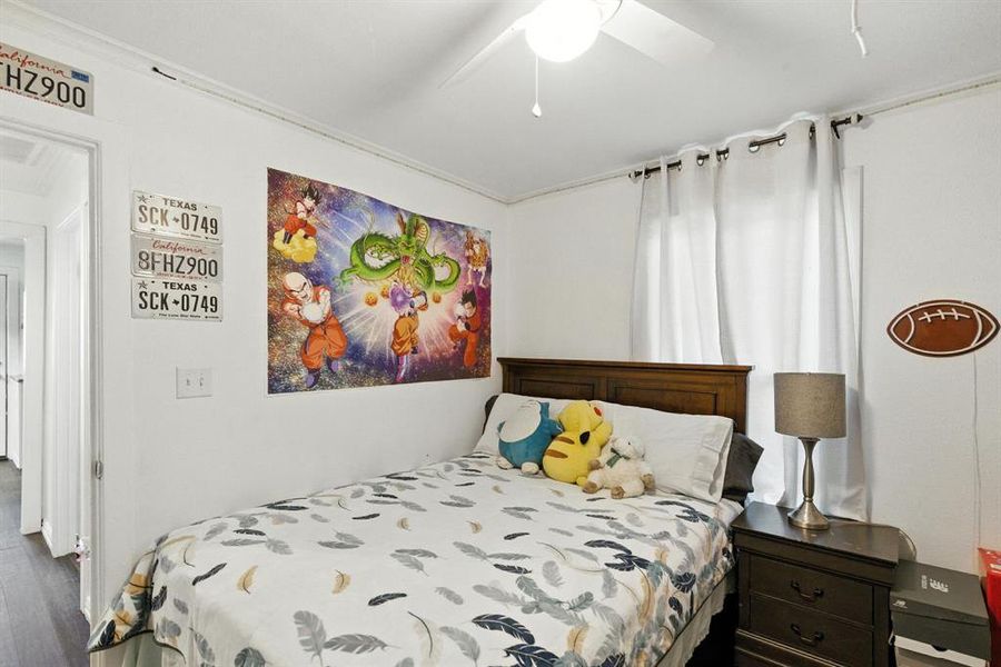 Bedroom featuring wood finished floors and a ceiling fan