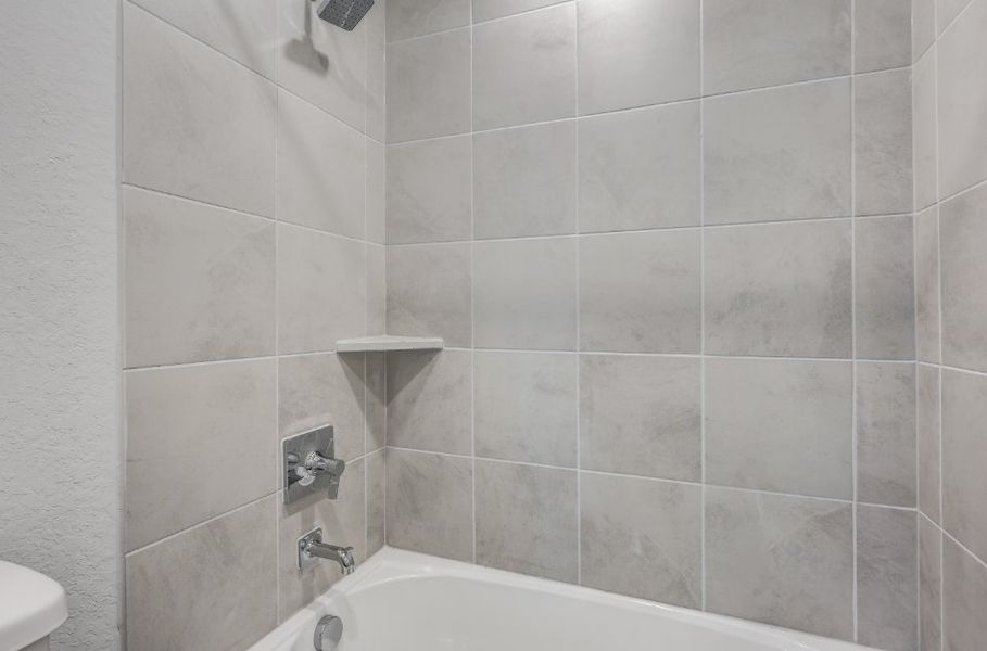 A white tiled bathroom.