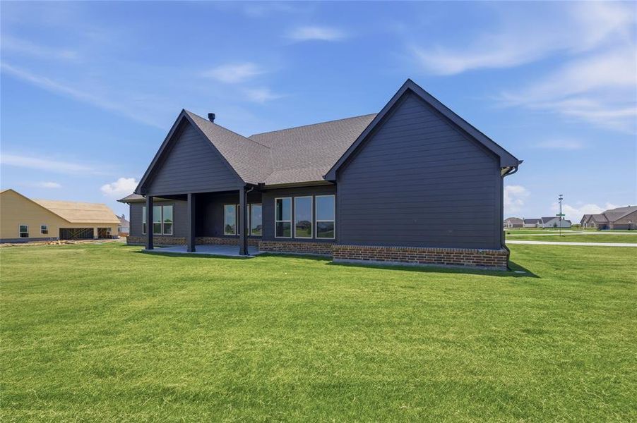 Contemporary exterior featuring dark horizontal siding and a brick skirting Contemporary exterior featuring dark horizontal siding and a brick skirting