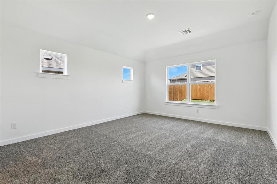 Carpeted empty room featuring baseboards Carpeted empty room featuring baseboards
