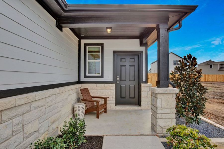 A house with a patio and a bench. A house with a patio and a bench.