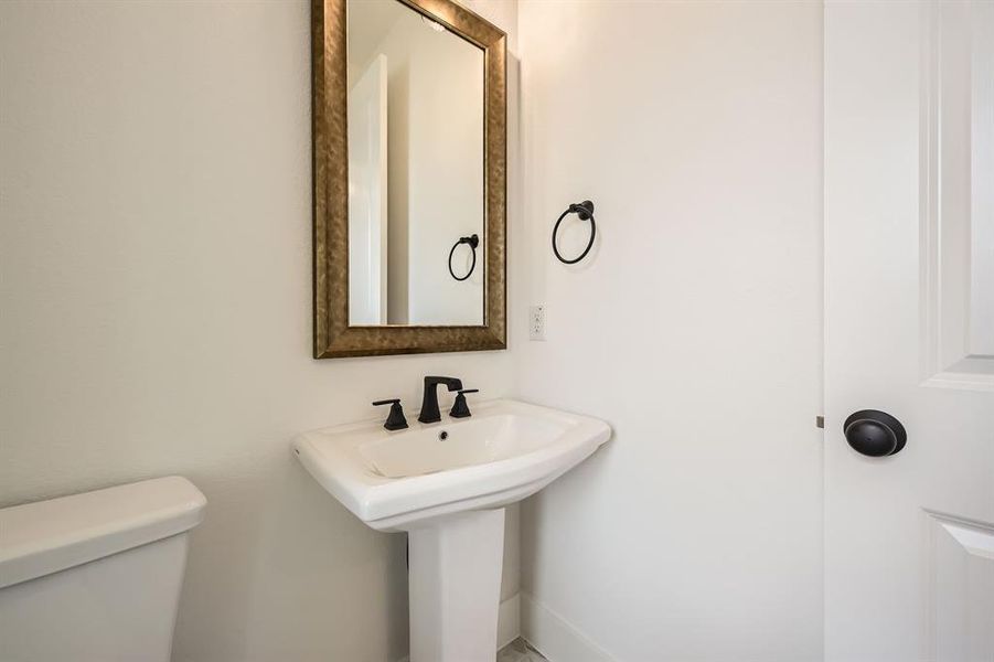 Half bathroom with toilet and baseboards Half bathroom with toilet and baseboards