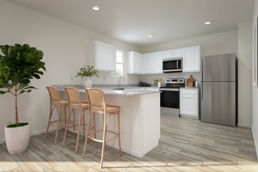 A kitchen with a table and chairs.