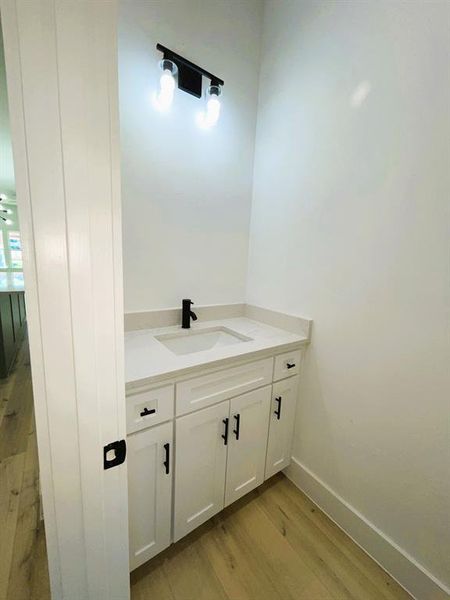 Bathroom featuring vanity and wood-type flooring