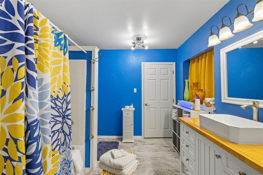 Full bath featuring shower / tub combo and vanity Full bath featuring shower / tub combo and vanity