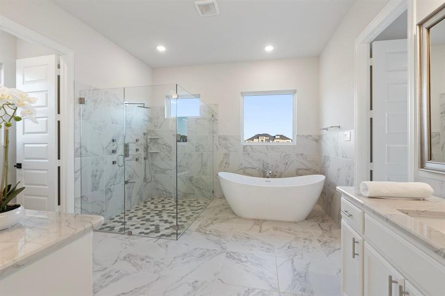 Bathroom with tile walls, vanity, and independent shower and bath