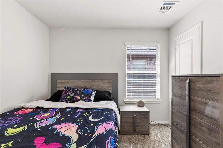 Bedroom featuring light colored carpet Bedroom featuring light colored carpet