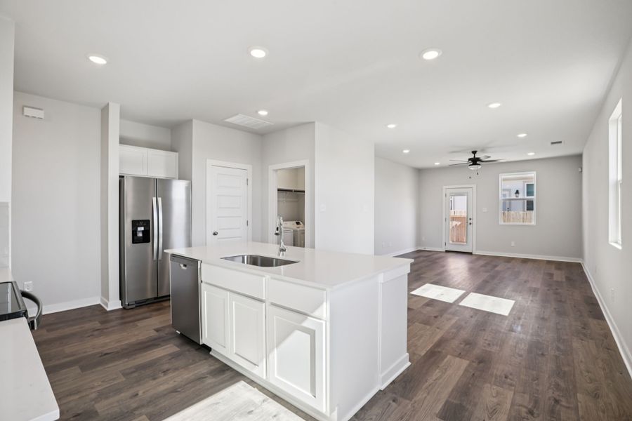 A kitchen with white cabinets.