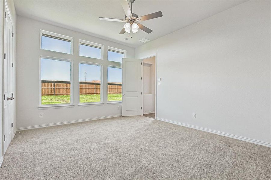 Spare room featuring ceiling fan and light colored carpet