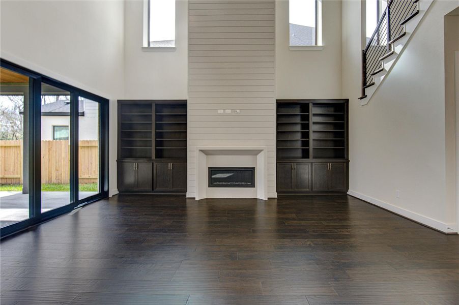 Stunning living room is perfectly located between access to the covered patio and the kitchen.