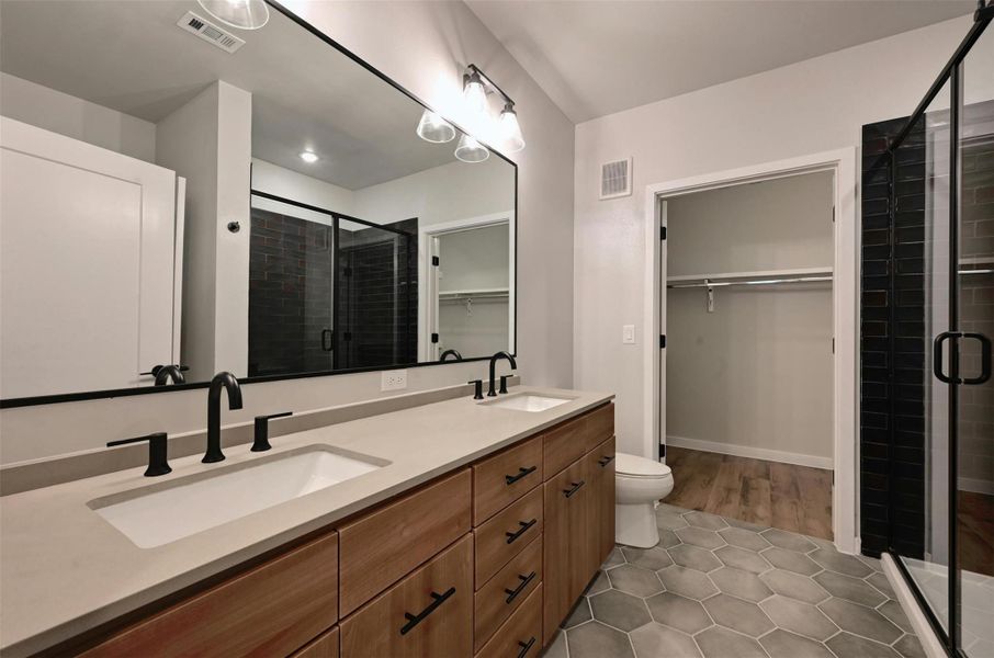 The spacious bathroom can be accessed through the bedroom or hallway. The walk-in closet is very spacious.