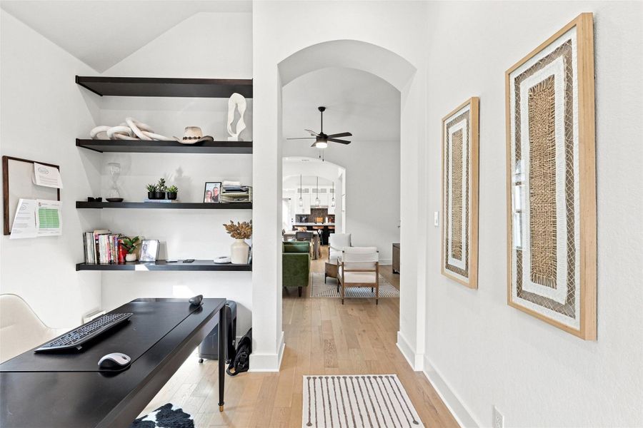 Gleaming hardwood floors and a lofty vaulted ceiling highlight this quiet home workspace.