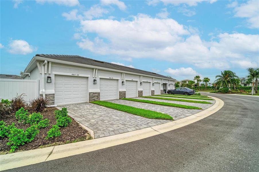 Front exterior of a new home in Esplanade at Azario Lakewood Ranch, Lakewood Ranch, FL, highlighting curb appeal (Image 24). Front exterior of a new home in Esplanade at Azario Lakewood Ranch, Lakewood Ranch, FL, highlighting curb appeal (Image 24).