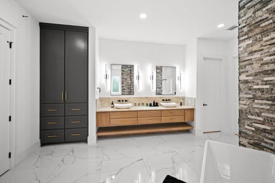 Spa-inspired bathroom featuring taj mahal countertops, freestanding soaking tub and large shower