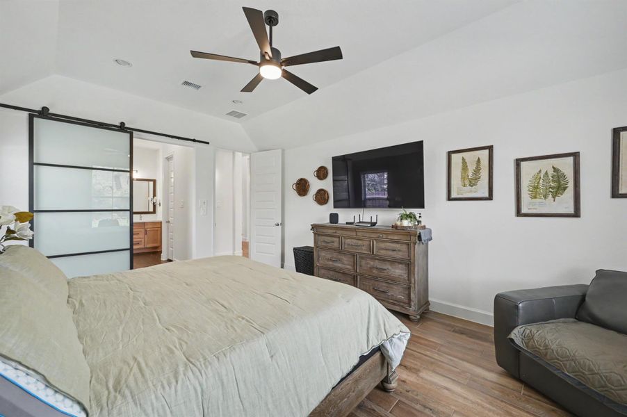The room has recessed lighting and a Kichler ceiling fan with wall controls. The modern barn door was an add on making the bathroom private while not taking space in the bedroom. The room has recessed lighting and a Kichler ceiling fan with wall controls. The modern barn door was an add on making the bathroom private while not taking space in the bedroom.