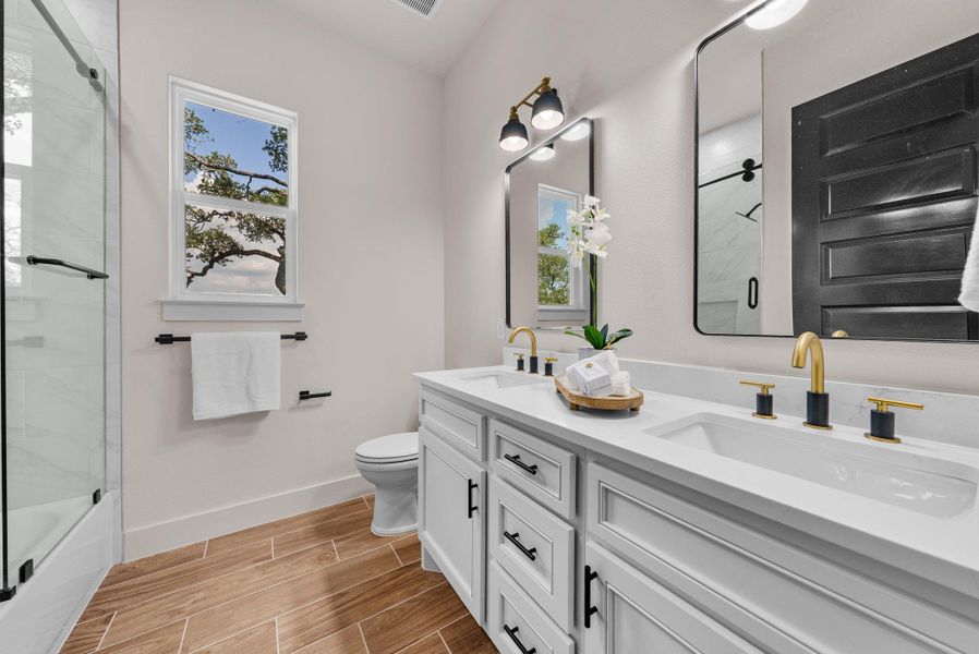 A well-appointed bathroom with a spacious vanity, dual sinks, and contemporary fixtures.
