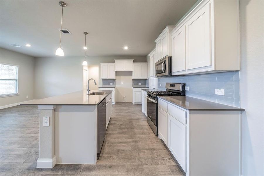 Kitchen has tons of counterspace and cabinets