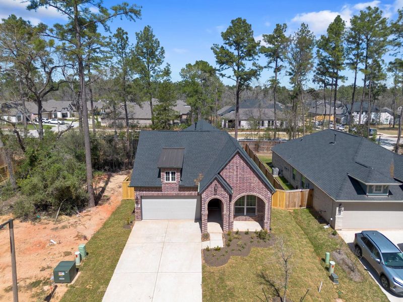 Front exterior of a new home in The Woodlands Hills, Willis, TX, highlighting curb appeal (Image 18). Front exterior of a new home in The Woodlands Hills, Willis, TX, highlighting curb appeal (Image 18).