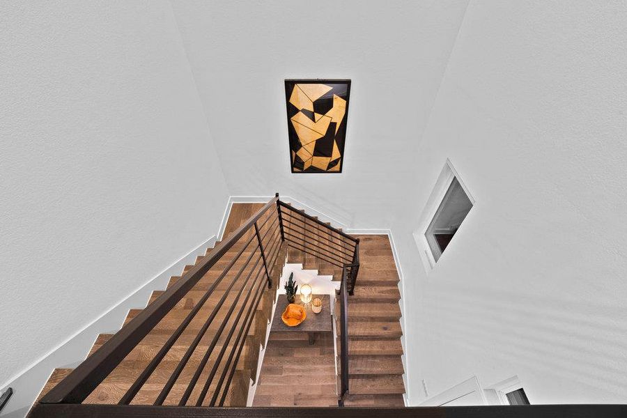 Stairway featuring a towering ceiling