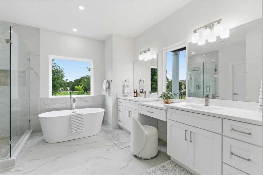 Complete with a dual vanity and dedicated makeup area, the spa-like bath offers both function and refined comfort.