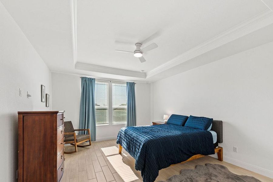 The tiled primary bedroom gets good light and has coffered ceilings.