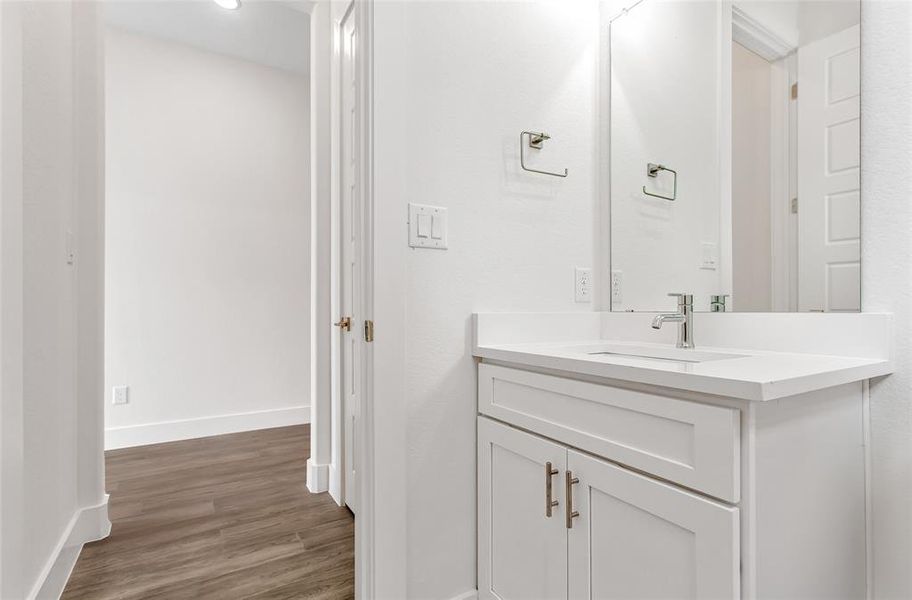 Bathroom with hardwood / wood-style flooring and vanity