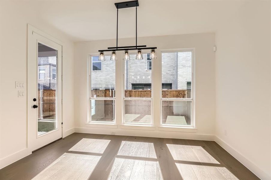 Unfurnished dining area featuring dark hardwood / wood-style floors