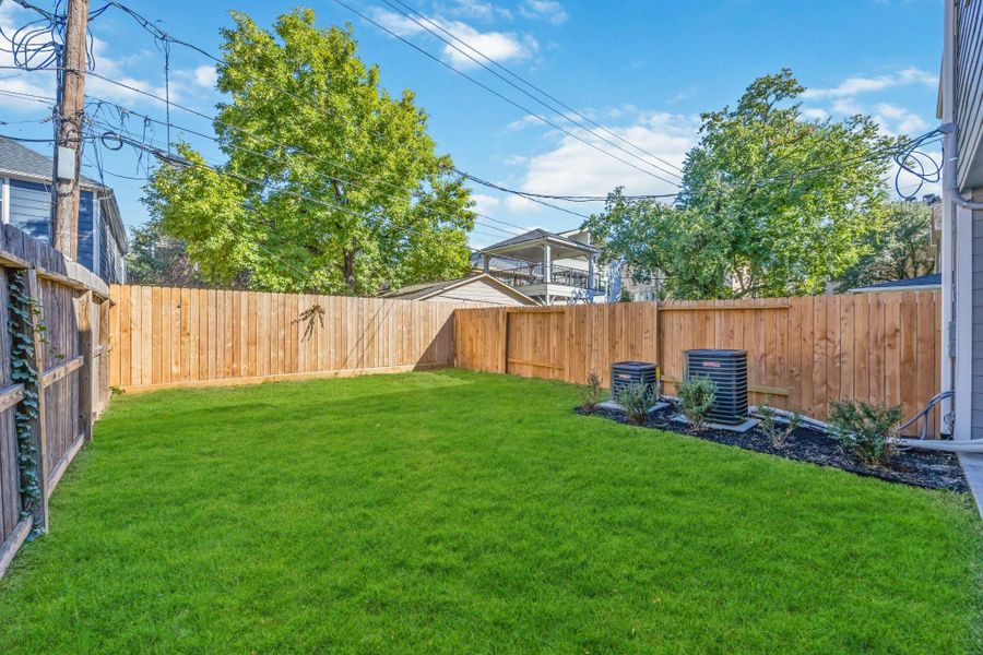 Slow mornings, garden dreams, and room to make it all your own. From the covered back porch, your backyard feels like a blank canvas—lush, private, and wrapped in a cedar fence for extra serenity. Whether you’re imagining raised beds, a playscape, or space for the dog to roam, this yard is ready for whatever “home” looks like to you. Slow mornings, garden dreams, and room to make it all your own. From the covered back porch, your backyard feels like a blank canvas—lush, private, and wrapped in a cedar fence for extra serenity. Whether you’re imagining raised beds, a playscape, or space for the dog to roam, this yard is ready for whatever “home” looks like to you.