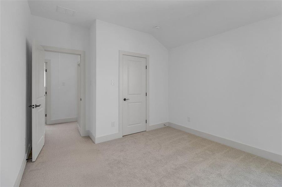 Neutral-toned carpet flooring complementing white walls and trim