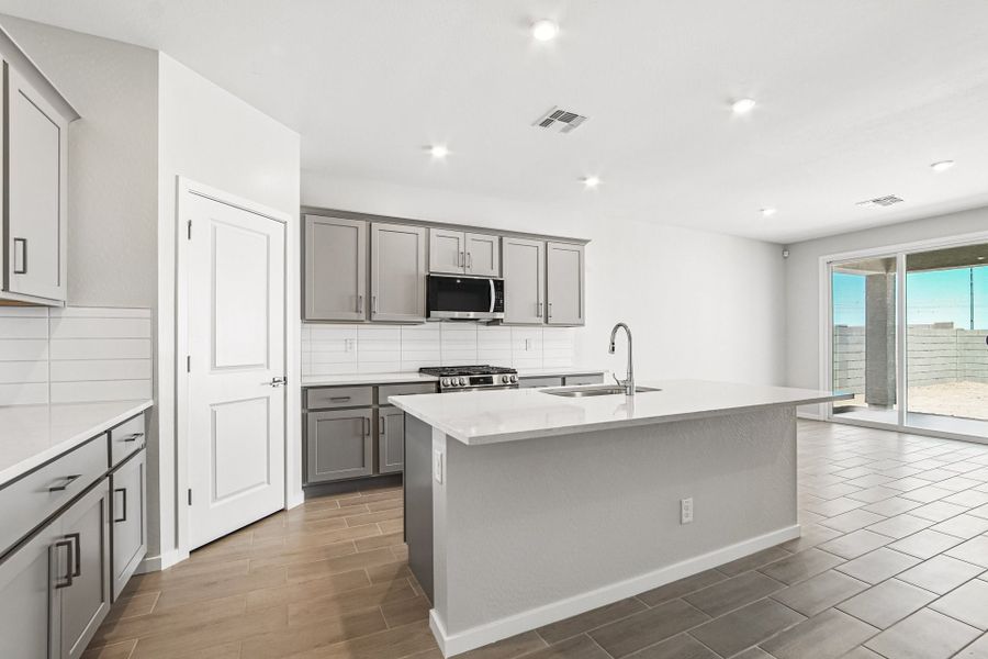 A kitchen with white cabinets.