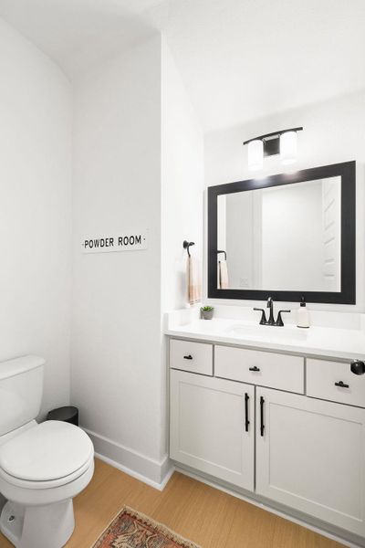 White vanity with shaker-style cabinetry, a white countertop, and a rectangular undermount sink White vanity with shaker-style cabinetry, a white countertop, and a rectangular undermount sink