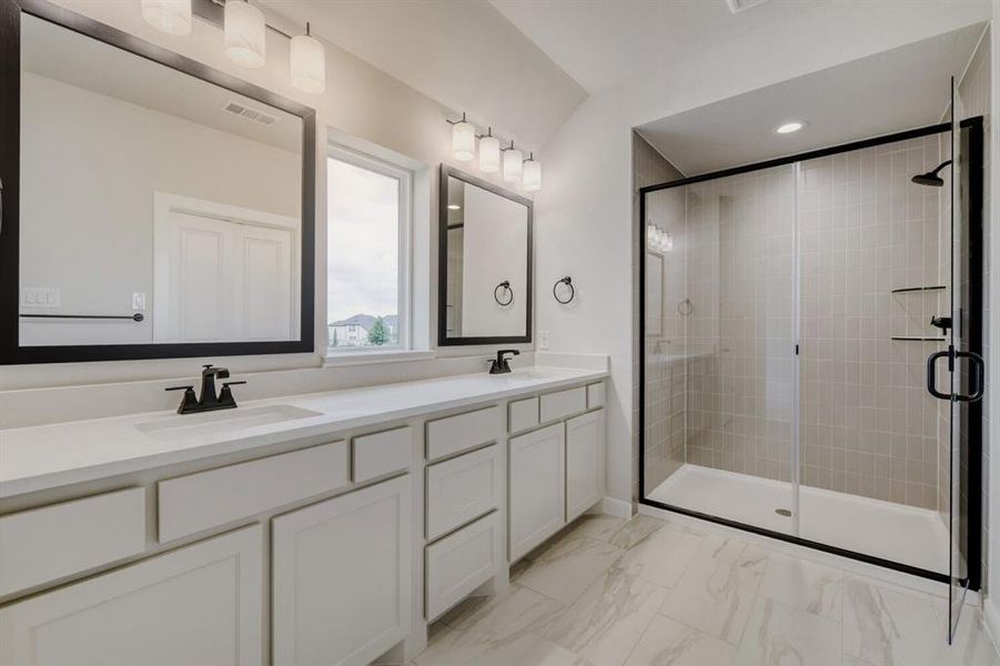 Double vanity featuring integrated sinks, white cabinetry, and a light-toned countertop